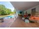 Stylish outdoor patio with poolside bar, lounge seating, and a view of the backyard pond at 1143 Sea Eagle Watch, Charleston, SC 29412
