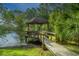 Quaint wooden pavilion on the edge of a pond surrounded by lush greenery and a wooden walkway at 1143 Sea Eagle Watch, Charleston, SC 29412