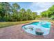 Inviting in-ground pool with sun chairs, lush landscaping, and a tranquil pond in the background at 1143 Sea Eagle Watch, Charleston, SC 29412