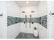 Large walk-in shower featuring white subway tile, a blue mosaic tile accent, and dual shower heads at 1143 Sea Eagle Watch, Charleston, SC 29412