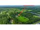 Aerial view of a home surrounded by lush greenery, highlighting its private setting and acreage at 120 Greenhill Pastures, Summerville, SC 29483