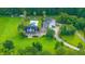Aerial view of a home with inground pool, palm trees, covered patio, and oversized garage at 120 Greenhill Pastures, Summerville, SC 29483