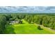 Beautiful aerial view of a property featuring a pool, green lawn, and surrounding forest at 120 Greenhill Pastures, Summerville, SC 29483