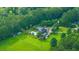 Aerial view of home featuring a pool, large lawn, detached garage, and mature trees at 120 Greenhill Pastures, Summerville, SC 29483
