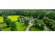 Wide aerial view of a beautiful home and property with mature trees, a circular drive, and green space at 120 Greenhill Pastures, Summerville, SC 29483