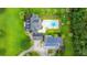 Aerial view of a property featuring a house, pool, garage, and surrounding landscaping at 120 Greenhill Pastures, Summerville, SC 29483
