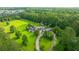 Aerial view of a luxury home featuring mature trees, a circular drive, a pool, and other amenities at 120 Greenhill Pastures, Summerville, SC 29483