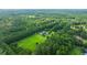 Lush aerial view of an estate with vast greenery, pool, and tree lined property at 120 Greenhill Pastures, Summerville, SC 29483