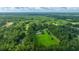 Aerial view of home featuring a pool, a vast lawn, trees, and nearby residences at 120 Greenhill Pastures, Summerville, SC 29483