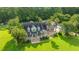 Spacious two-story home with a brick facade, large front yard, mature trees and a welcoming front porch at 120 Greenhill Pastures, Summerville, SC 29483
