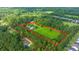 Expansive property featuring a luxurious home, sparkling pool, lush lawn, and dense surrounding trees offers privacy at 120 Greenhill Pastures, Summerville, SC 29483