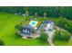 Aerial view of home with an inground pool, palm trees, covered patio, and garage at 120 Greenhill Pastures, Summerville, SC 29483