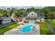 Backyard pool with a slide, lounge chairs, patio dining set and mature trees for summer fun at 120 Greenhill Pastures, Summerville, SC 29483