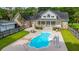 Backyard pool with a slide, lounge chairs, patio dining set and mature trees for summer fun at 120 Greenhill Pastures, Summerville, SC 29483