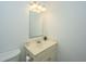 Compact bathroom vanity with ample lighting, framed mirror, neutral paint, and toilet at 120 Greenhill Pastures, Summerville, SC 29483