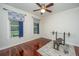 Cozy bedroom with hardwood floors, ceiling fan, natural light, and home gym equipment at 120 Greenhill Pastures, Summerville, SC 29483