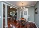 Bright breakfast nook with hardwood floors and elegant chandelier, adjacent to spacious living area at 120 Greenhill Pastures, Summerville, SC 29483