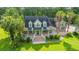Charming home with a brick facade, white trim, dormer windows and a welcoming front porch with swing benches at 120 Greenhill Pastures, Summerville, SC 29483