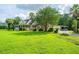 Exterior view of a house with a large front yard, covered porch, and attached garage at 120 Greenhill Pastures, Summerville, SC 29483