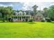 Exterior view of a house with a large front yard and a covered porch at 120 Greenhill Pastures, Summerville, SC 29483