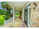 Close up of the front porch and door with brick accents, welcome mat, and beautiful landscaping at 120 Greenhill Pastures, Summerville, SC 29483