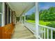 Inviting front porch with wooden bench, offering a relaxing outdoor space with picturesque views at 120 Greenhill Pastures, Summerville, SC 29483
