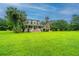 Two-story traditional home with manicured lawn, a covered front porch, and mature landscaping at 120 Greenhill Pastures, Summerville, SC 29483