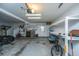 A car and bicycle are parked in an open garage with utility lighting, a wash sink, and side shelves at 120 Greenhill Pastures, Summerville, SC 29483