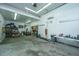 Open garage with utility lighting, ample room for storage and projects, with additional storage off to the sides at 120 Greenhill Pastures, Summerville, SC 29483