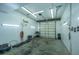 Spacious garage with an overhead door, utility lighting, and concrete flooring is ready for storage and more at 120 Greenhill Pastures, Summerville, SC 29483