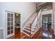Hallway with hardwood floors leads to a staircase and an adjacent room at 120 Greenhill Pastures, Summerville, SC 29483