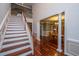 Hallway with wood staircase leads to the dining room at 120 Greenhill Pastures, Summerville, SC 29483