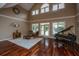 Expansive living room boasts hardwood floors, natural light, and features a piano at 120 Greenhill Pastures, Summerville, SC 29483