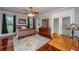 Comfortable primary bedroom with hardwood floors, ceiling fan, and ample natural light at 120 Greenhill Pastures, Summerville, SC 29483