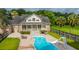 Backyard pool with a slide, lounge chairs, patio dining set and mature trees for summer fun at 120 Greenhill Pastures, Summerville, SC 29483