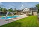 Backyard pool area features a slide, lounge chairs, and a well-maintained lawn at 120 Greenhill Pastures, Summerville, SC 29483