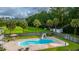 Backyard pool with a slide, surrounded by mature trees and a privacy fence for outdoor entertainment at 120 Greenhill Pastures, Summerville, SC 29483