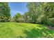 An expansive green backyard with a pond and lush tropical landscaping at 1208 Wynnwood Ct, Mount Pleasant, SC 29466