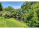 Lush backyard with well-maintained greenery, landscaping and a pond in the background at 1208 Wynnwood Ct, Mount Pleasant, SC 29466