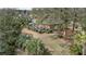 Aerial view of the home showcasing the outdoor patio, lush yard, and mature trees at 1208 Wynnwood Ct, Mount Pleasant, SC 29466