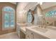 Bright bathroom featuring a double vanity with marble counters, decorative mirror, and ample natural light at 1208 Wynnwood Ct, Mount Pleasant, SC 29466