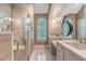 Bright bathroom featuring a double vanity with marble counters, decorative mirror, and tiled walk-in shower at 1208 Wynnwood Ct, Mount Pleasant, SC 29466