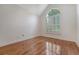 Sun-drenched bedroom with hardwood floors and large arched window with plantation shutters at 1208 Wynnwood Ct, Mount Pleasant, SC 29466
