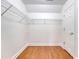 Walk-in closet with wood floors and metal shelving for optimal organization at 1208 Wynnwood Ct, Mount Pleasant, SC 29466