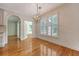 Bright dining room features hardwood floors, large window, and modern light fixture at 1208 Wynnwood Ct, Mount Pleasant, SC 29466