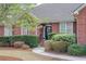 Close-up of a brick home exterior with landscaped bushes and front door at 1208 Wynnwood Ct, Mount Pleasant, SC 29466