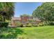 Exterior of a brick house with manicured lawn, landscaping, and a spacious backyard at 1208 Wynnwood Ct, Mount Pleasant, SC 29466