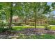 Charming red brick home featuring a well-manicured lawn, mature trees, and lovely curb appeal at 1208 Wynnwood Ct, Mount Pleasant, SC 29466