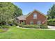 Charming brick home featuring a well-manicured lawn, lush greenery, and classic architectural details at 1208 Wynnwood Ct, Mount Pleasant, SC 29466