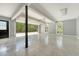 Large garage with epoxy flooring, gray walls, overhead lighting and a partially open door at 1208 Wynnwood Ct, Mount Pleasant, SC 29466